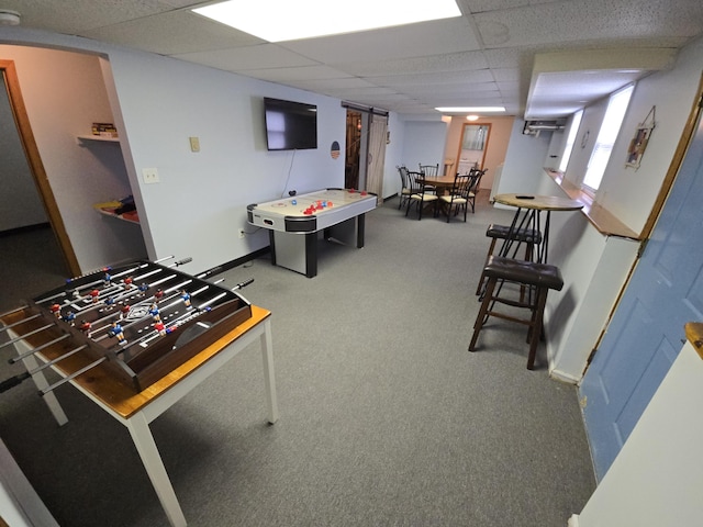 game room featuring carpet and a drop ceiling