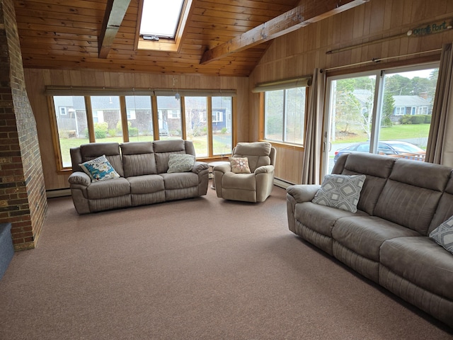 carpeted living room featuring vaulted ceiling with skylight, wood ceiling, baseboard heating, and wood walls