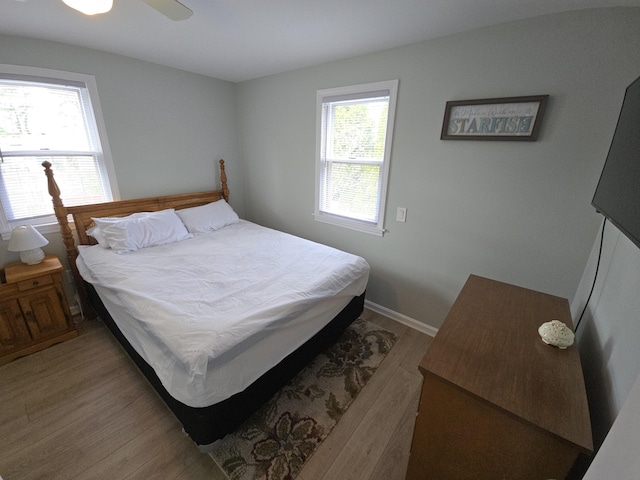 bedroom with baseboards and light wood-style flooring