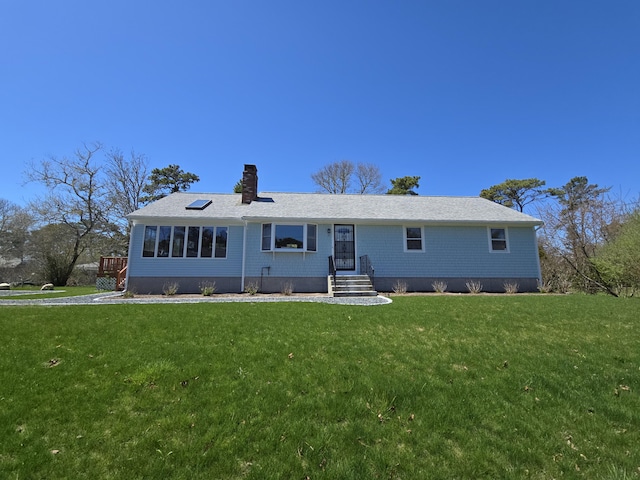 ranch-style house featuring a front lawn and a chimney