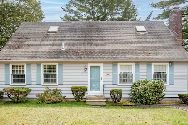 cape cod home with a front lawn