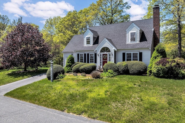 72 Rosemary Ln, Centerville, MA 02632 - cape cod house with a front lawn, a chimney, and a shingled roof