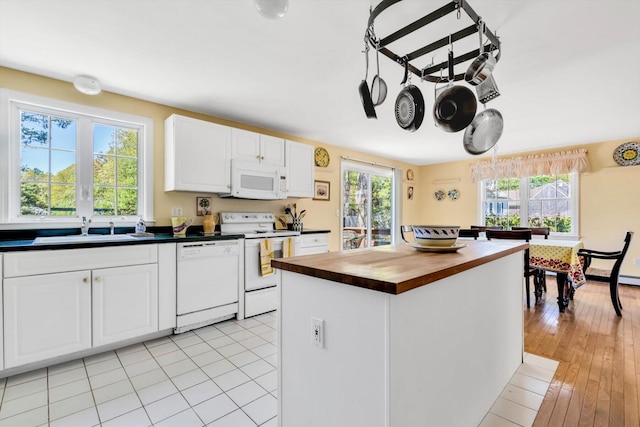 72 Rosemary Ln, Centerville, MA 02632 - kitchen with white appliances, a sink, wood counters, white cabinetry, and a kitchen island