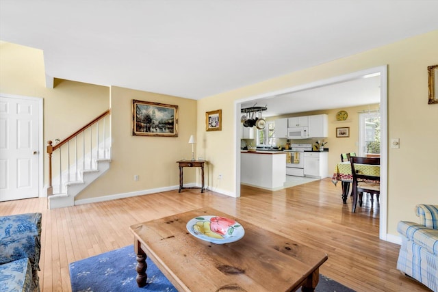 72 Rosemary Ln, Centerville, MA 02632 - living area featuring light wood-type flooring, stairway, and baseboards