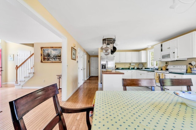 72 Rosemary Ln, Centerville, MA 02632 - dining area with light wood-type flooring, stairway, and baseboards