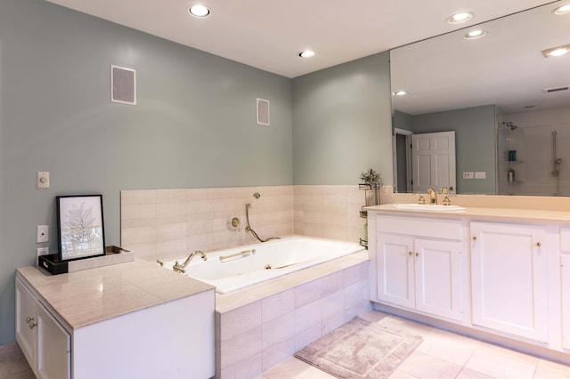 bathroom with tile patterned floors, vanity, and independent shower and bath