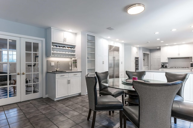 dining area featuring indoor wet bar and french doors