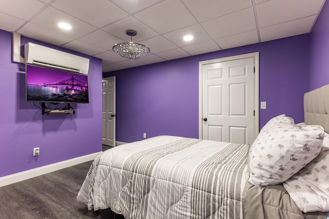 bedroom with wood-type flooring and a wall mounted air conditioner