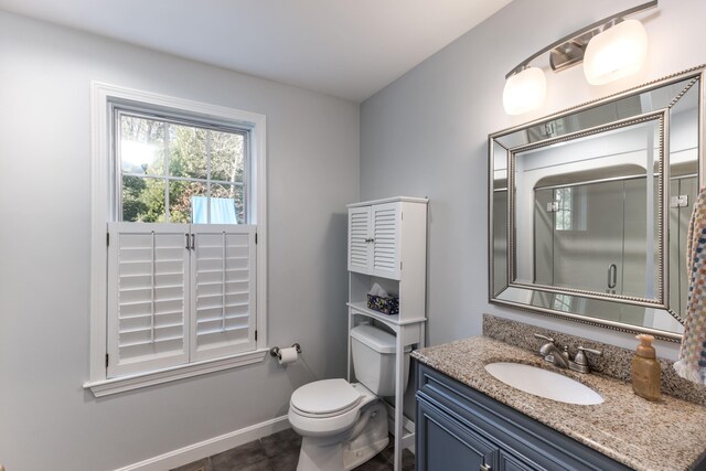 bathroom featuring vanity, toilet, and tile patterned flooring