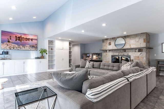 tiled living room featuring vaulted ceiling and a fireplace