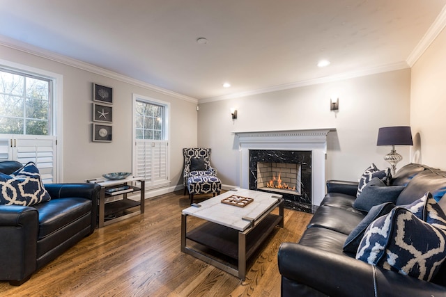 living room featuring crown molding, hardwood / wood-style flooring, and a high end fireplace