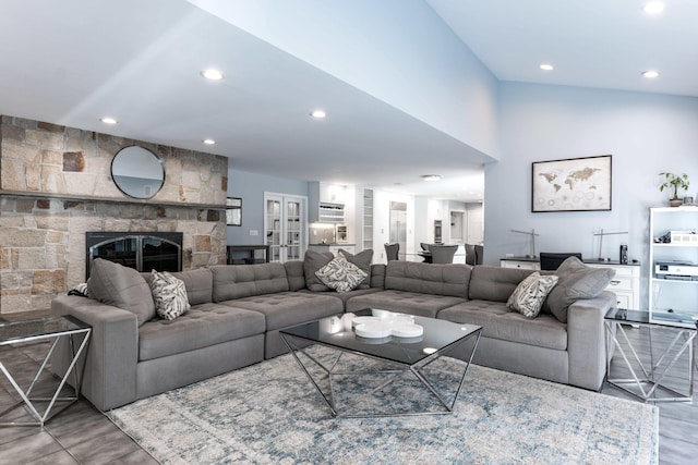 living room with a stone fireplace