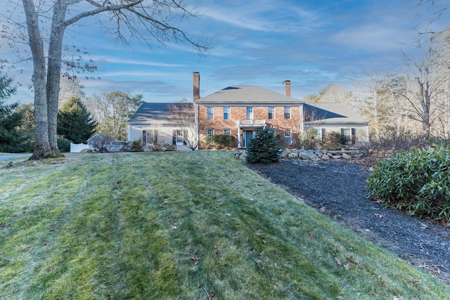 rear view of house with a lawn