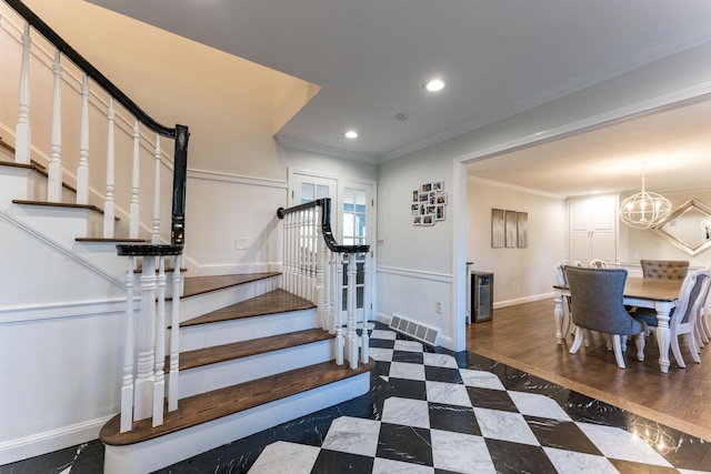 staircase featuring ornamental molding, wine cooler, and an inviting chandelier