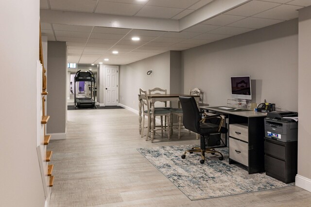 office area featuring a drop ceiling and light wood-type flooring