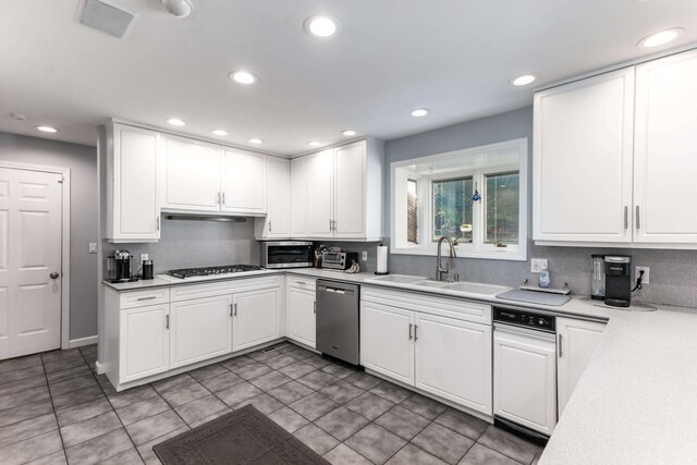 kitchen featuring white cabinets, light tile patterned floors, appliances with stainless steel finishes, and sink