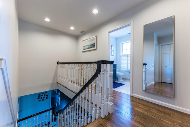 staircase featuring hardwood / wood-style floors