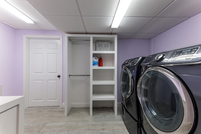 laundry area with light hardwood / wood-style flooring and independent washer and dryer