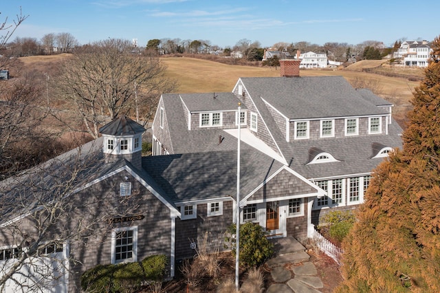 shingle-style home featuring a shingled roof