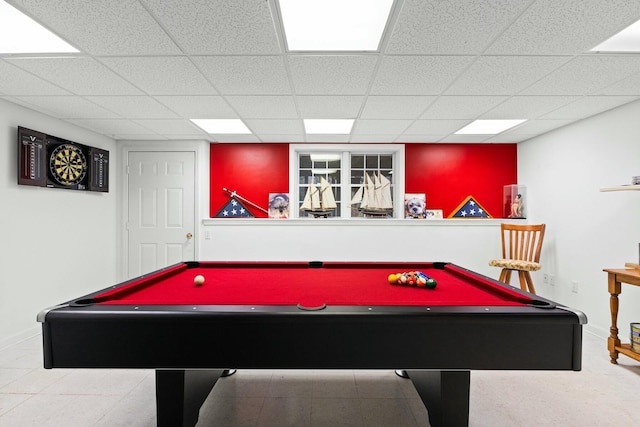 playroom with a paneled ceiling and baseboards