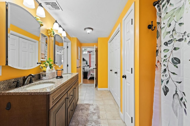 bathroom featuring a closet, visible vents, vanity, ensuite bath, and tile patterned flooring