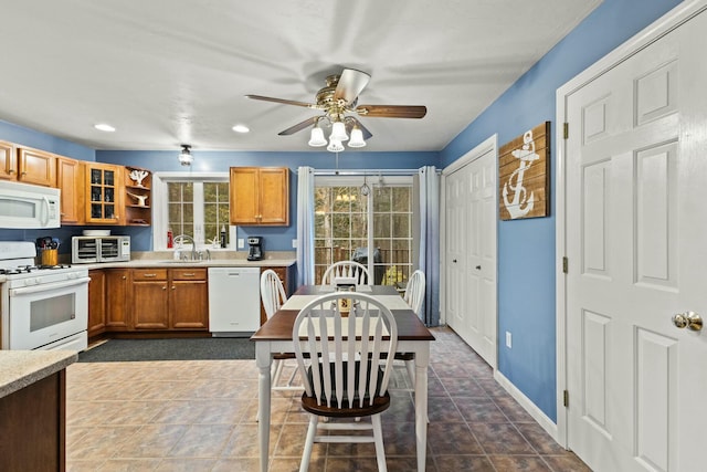 kitchen featuring open shelves, white appliances, light countertops, and brown cabinetry