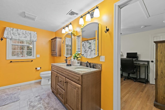 full bathroom featuring toilet, baseboards, visible vents, and vanity