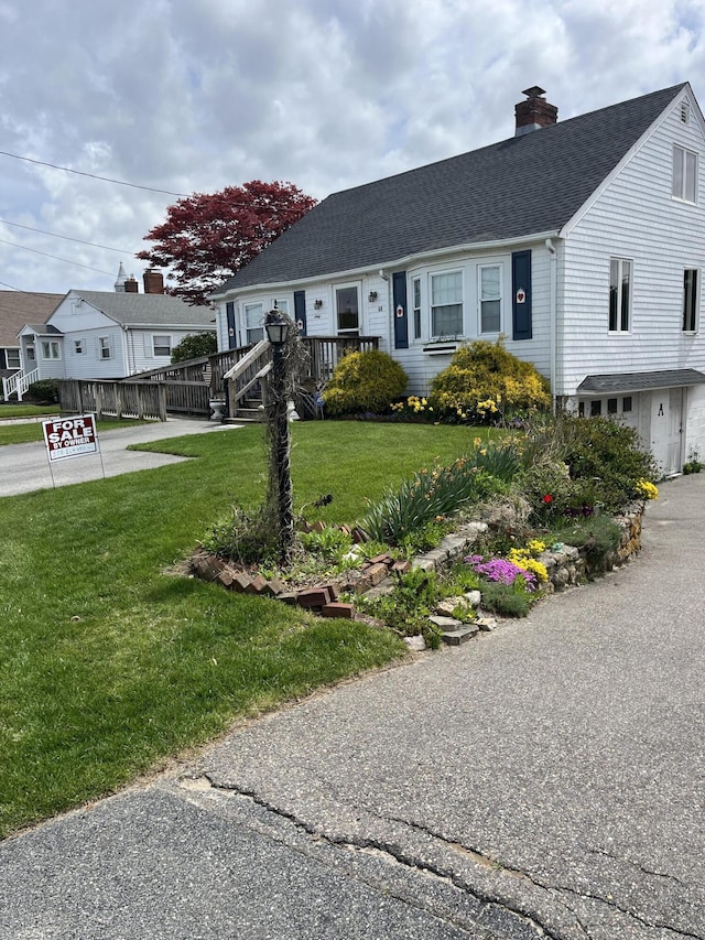 60 Academy Dr, Buzzards Bay, MA 02532 - view of front of house featuring roof with shingles, a chimney, and a front yard