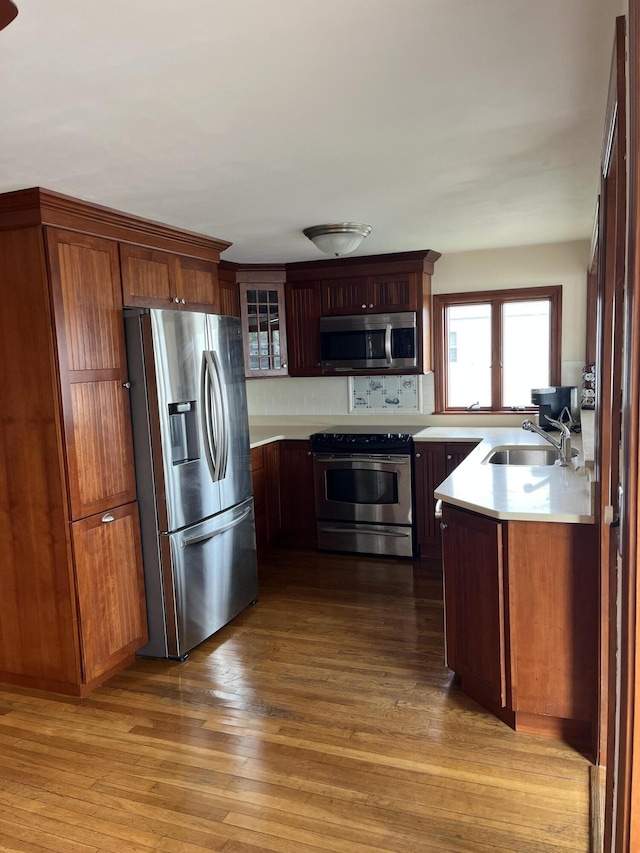 60 Academy Dr, Buzzards Bay, MA 02532 - kitchen featuring stainless steel appliances, a sink, light countertops, and glass insert cabinets