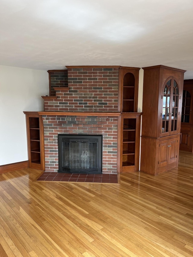 60 Academy Dr, Buzzards Bay, MA 02532 - unfurnished living room with hardwood / wood-style flooring, a fireplace, and baseboards