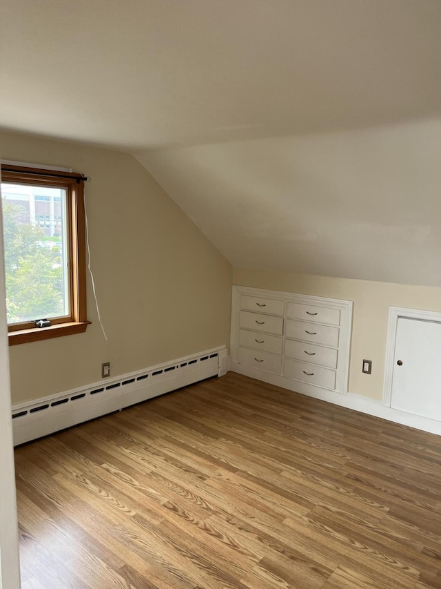 60 Academy Dr, Buzzards Bay, MA 02532 - additional living space with a baseboard radiator, light wood finished floors, vaulted ceiling, and baseboards