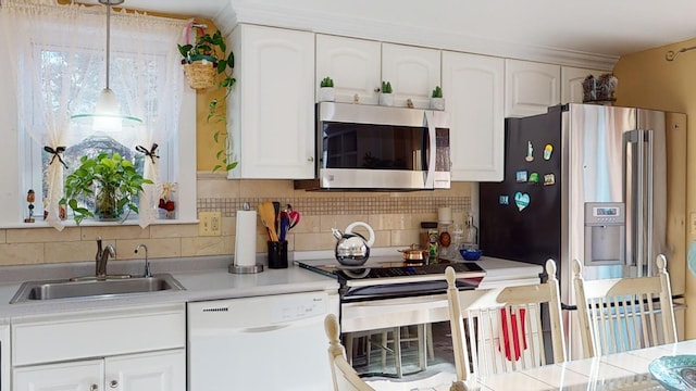 kitchen with decorative backsplash, sink, white cabinets, and stainless steel appliances