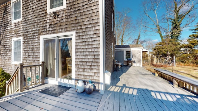 wooden terrace featuring a shed