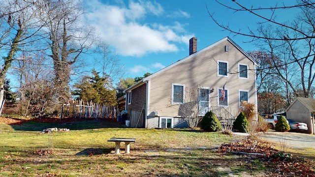 view of home's exterior with a lawn