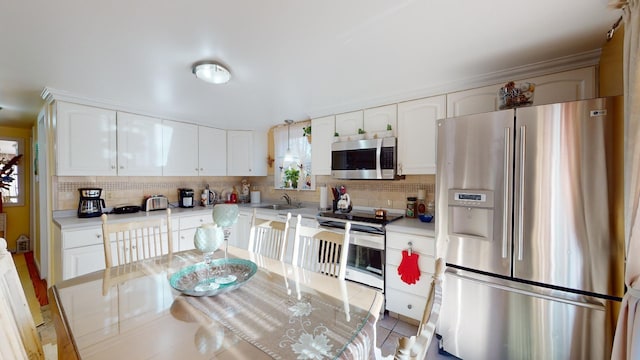 kitchen with white cabinetry, tile patterned floors, and stainless steel appliances