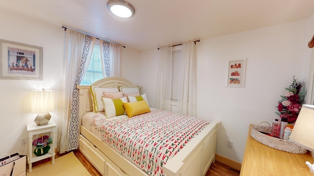 bedroom with hardwood / wood-style floors