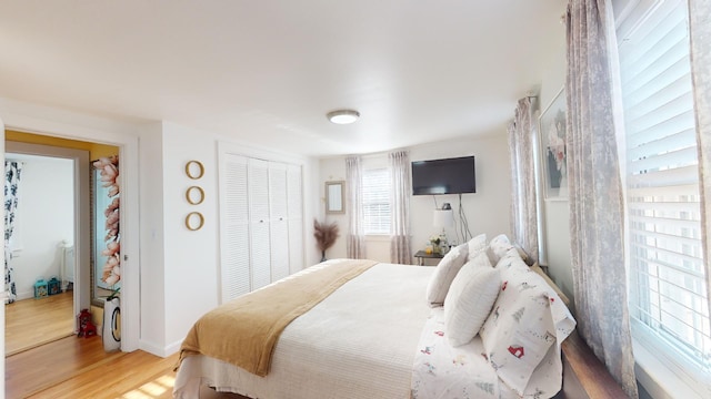 bedroom featuring hardwood / wood-style flooring and a closet