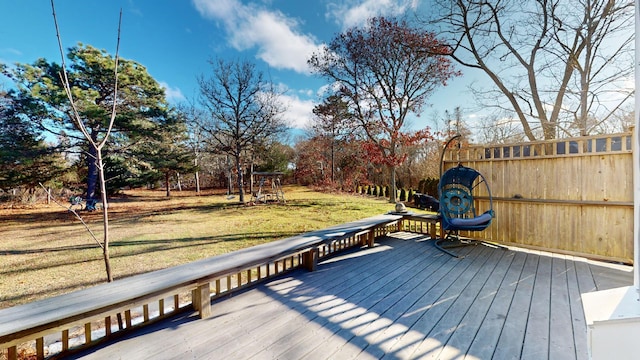 wooden terrace featuring a yard