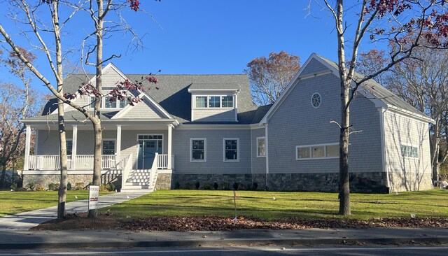 view of front of house with a front yard and covered porch