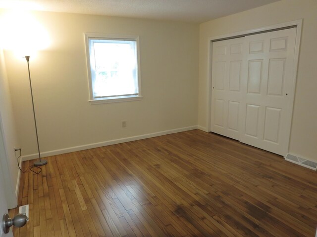 130 Fuller Rd, Centerville, MA 02632 - unfurnished bedroom featuring hardwood / wood-style floors, baseboards, and a closet