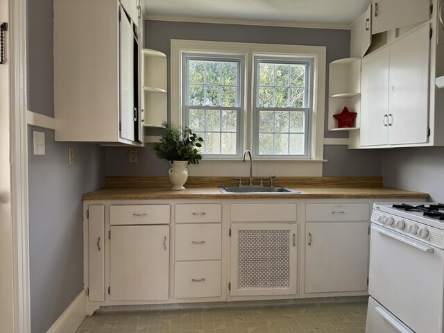 kitchen with white cabinetry, white range with gas cooktop, butcher block counters, sink, and crown molding