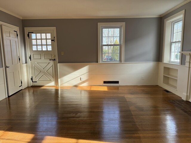 interior space featuring wood-type flooring and ornamental molding