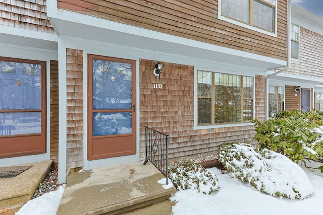 view of snow covered property entrance