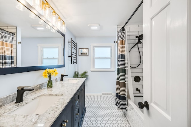 full bath with shower / bath combination with curtain, double vanity, a sink, and baseboards