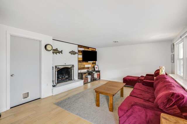 living room featuring a fireplace and light wood-style floors