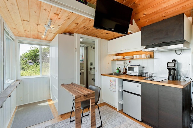 963 Commercial St Unit U30, Provincetown, MA 02657 - kitchen with refrigerator, wood ceiling, light wood finished floors, white microwave, and electric cooktop