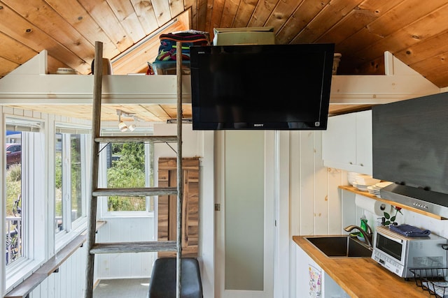 963 Commercial St Unit U30, Provincetown, MA 02657 - kitchen with vaulted ceiling, wooden ceiling, wooden counters, and white cabinetry