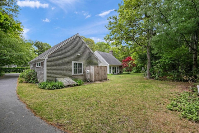 181 Pleasant St, South Yarmouth, MA 02664 - view of property exterior featuring a yard and a chimney