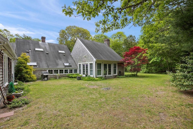 181 Pleasant St, South Yarmouth, MA 02664 - rear view of property with a chimney and a yard
