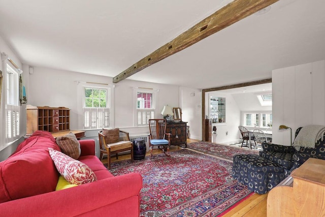 181 Pleasant St, South Yarmouth, MA 02664 - living room featuring wood finished floors, a skylight, and beamed ceiling